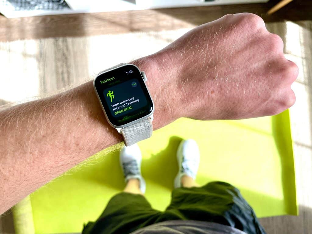 Person looking at their smartwatch, ready to start a HIIT workout.