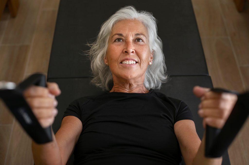 A woman engaging in a resistance training, representing the significance of strength and flexibility in a training regimen.