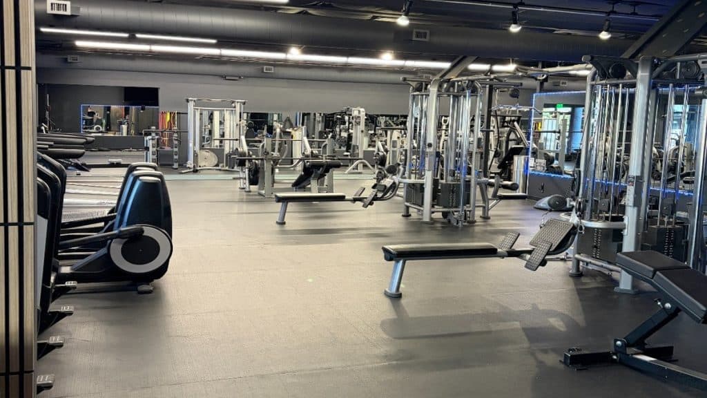 Spacious strength training floor at Peak Fitness San Luis Obispo with machines, benches, and open workout space