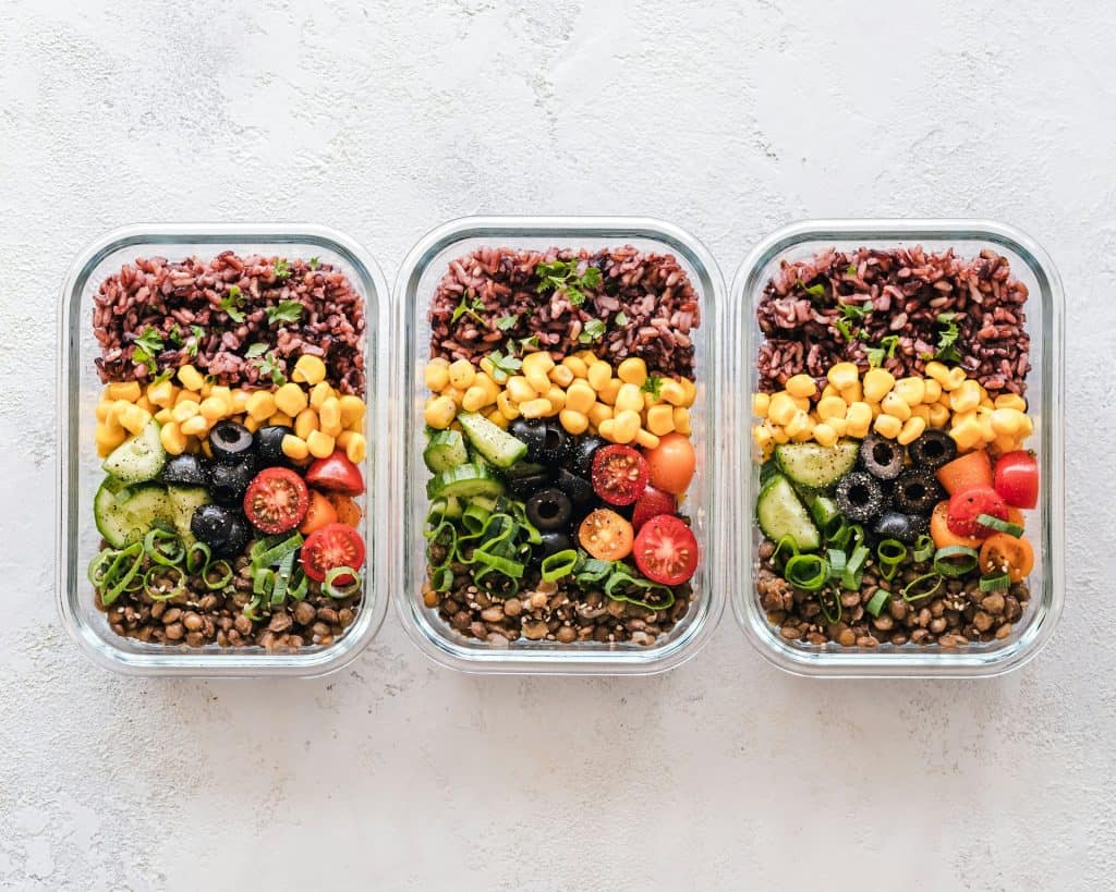 Colorful meal prep containers filled with balanced, portioned meals for a weekly nutrition plan