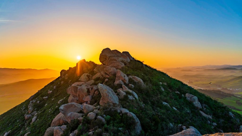 Rocky summit ridge of Bishop Peak at sunset with panoramic views of San Luis Obispo and the Central Coast