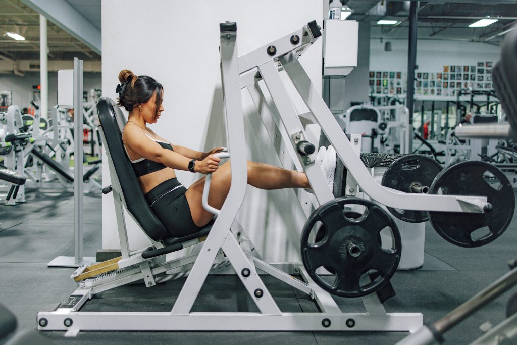 Woman performing a leg press exercise as part of a lower body strength training workout