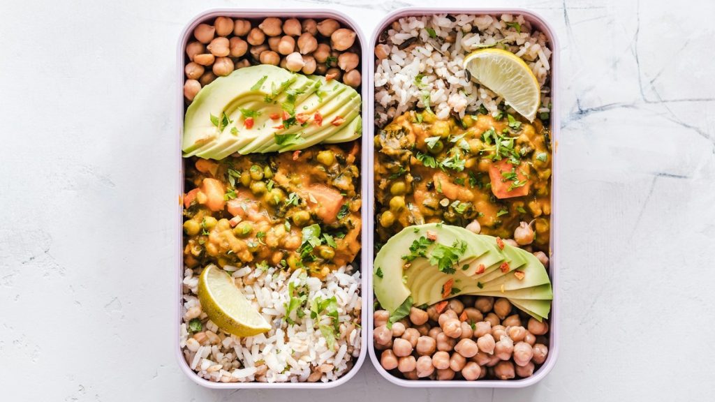 Portioned meal prep boxes with rice, chickpeas, and avocado for the week